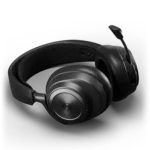 A black wireless headset with a microphone rests on a gray surface. The SteelSeries logo is visible on the ear cups.